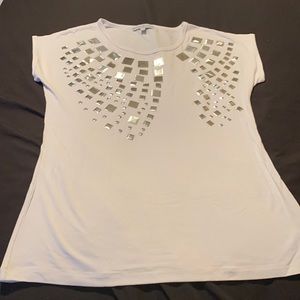 Woman’s dress top with silver metallic details.